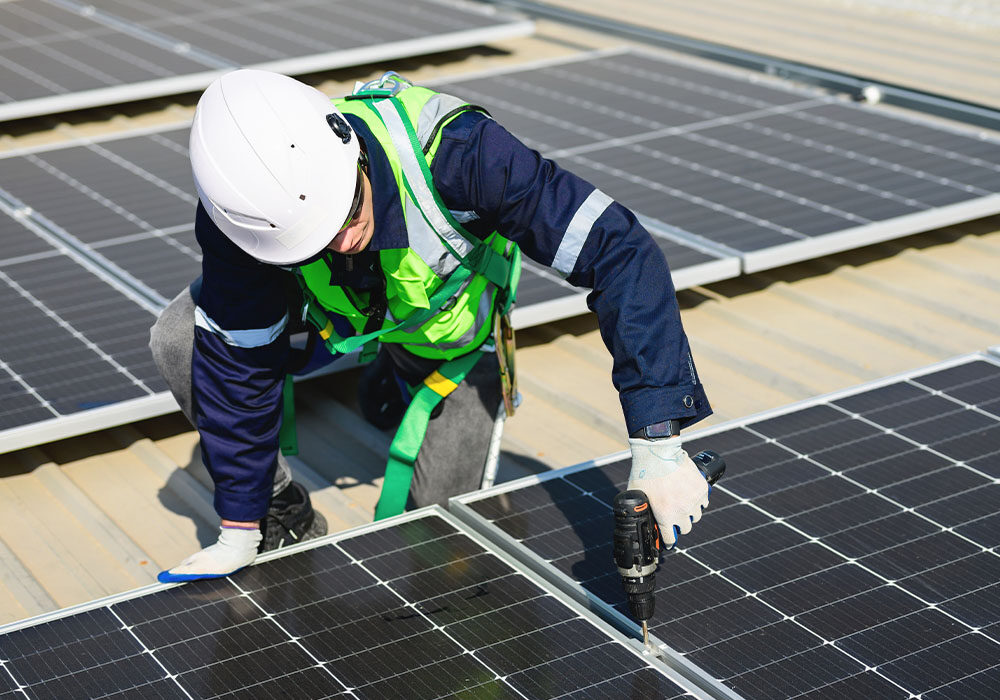 man in hard hat installing solar panels