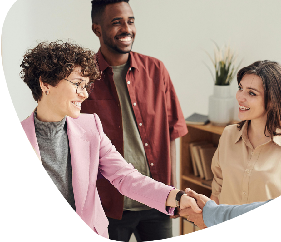 three workers smiling and shaking hands