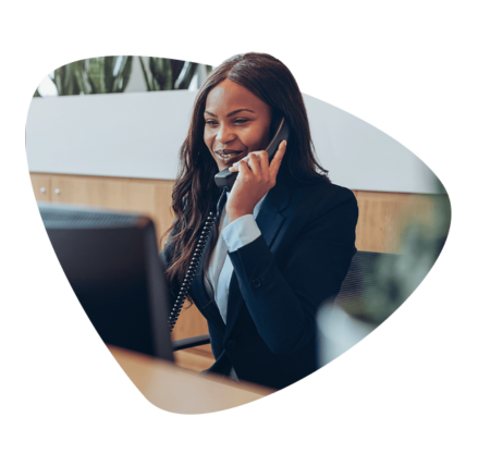 woman in suit on phone and smiling